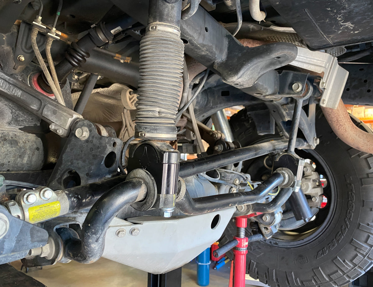 Rear KDSS drop brackets installed on the rear of a Toyota 4Runner. These Black Gate Customs brackets prevent the sway bar from contacting the track bar at full droop. If you want to run long travel shocks, these are highly recommended for those with KDSS equipped vehicles.