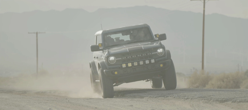 Ford Bronco driving from the street to dirt road