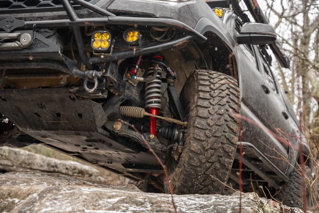 Tacoma rock crawling on rocks covered with snow and ice