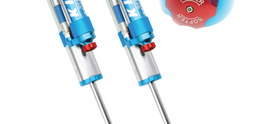 a pair of blue and silver King Shocks with remote reservoirs and compression adjusters